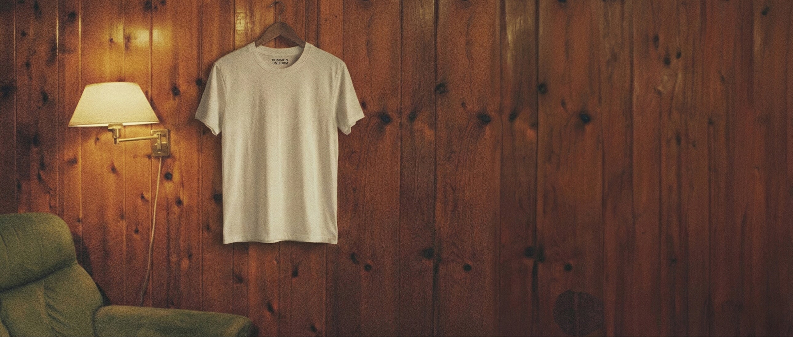 Common Uniform T-shirt hanging on the wall.