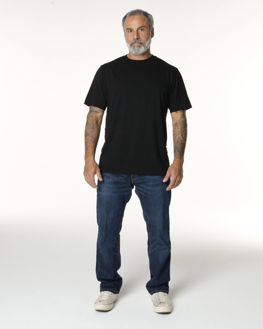 Man full body, wearing a black Premium t-shirt. Model is 5'11", 198lbs wearing size L