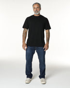 Man full body, wearing a black Premium t-shirt. Model is 5'11", 198lbs wearing size L