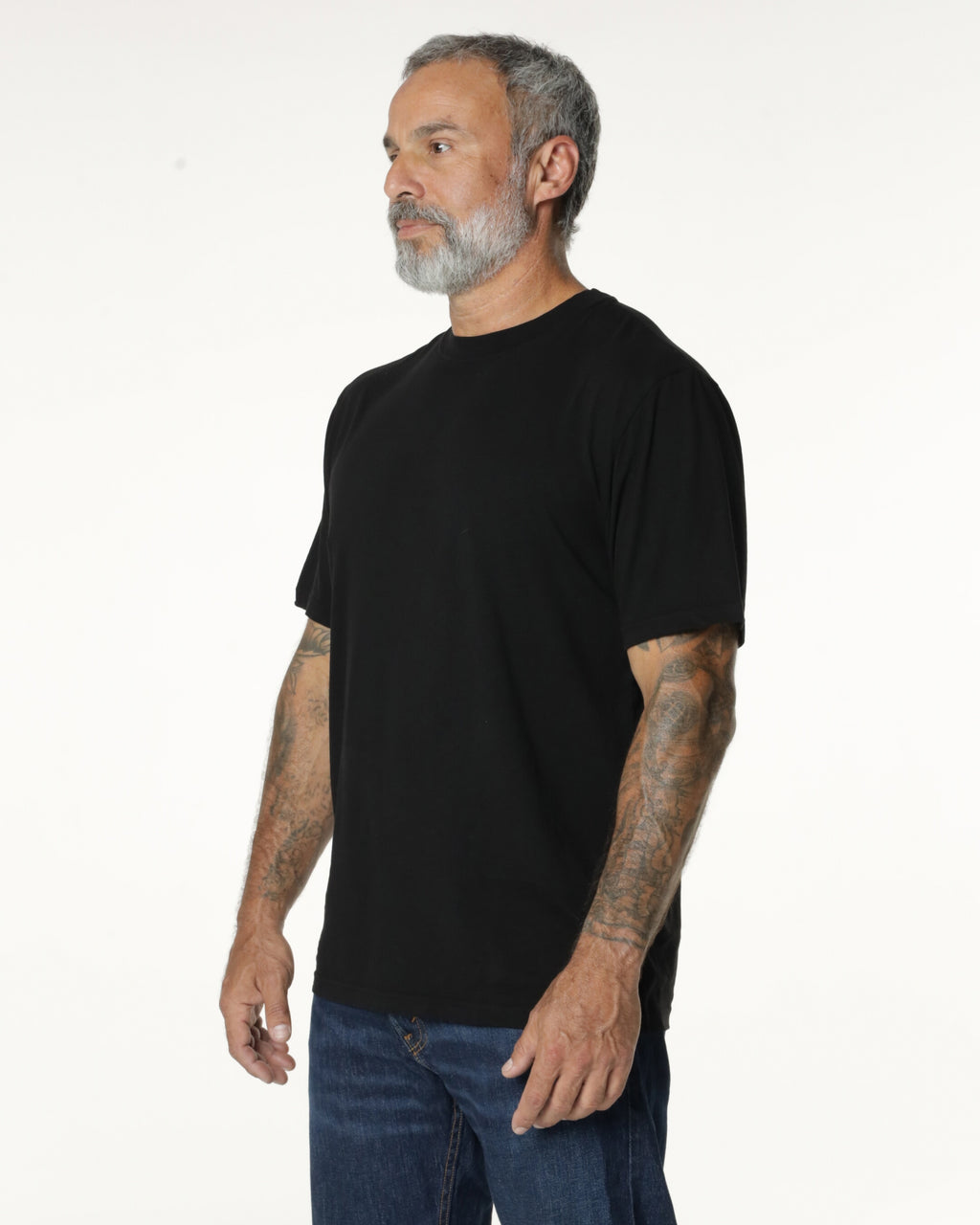 Man turned to the side, wearing a black Premium t-shirt. Model is 5'11", 198lbs wearing size L