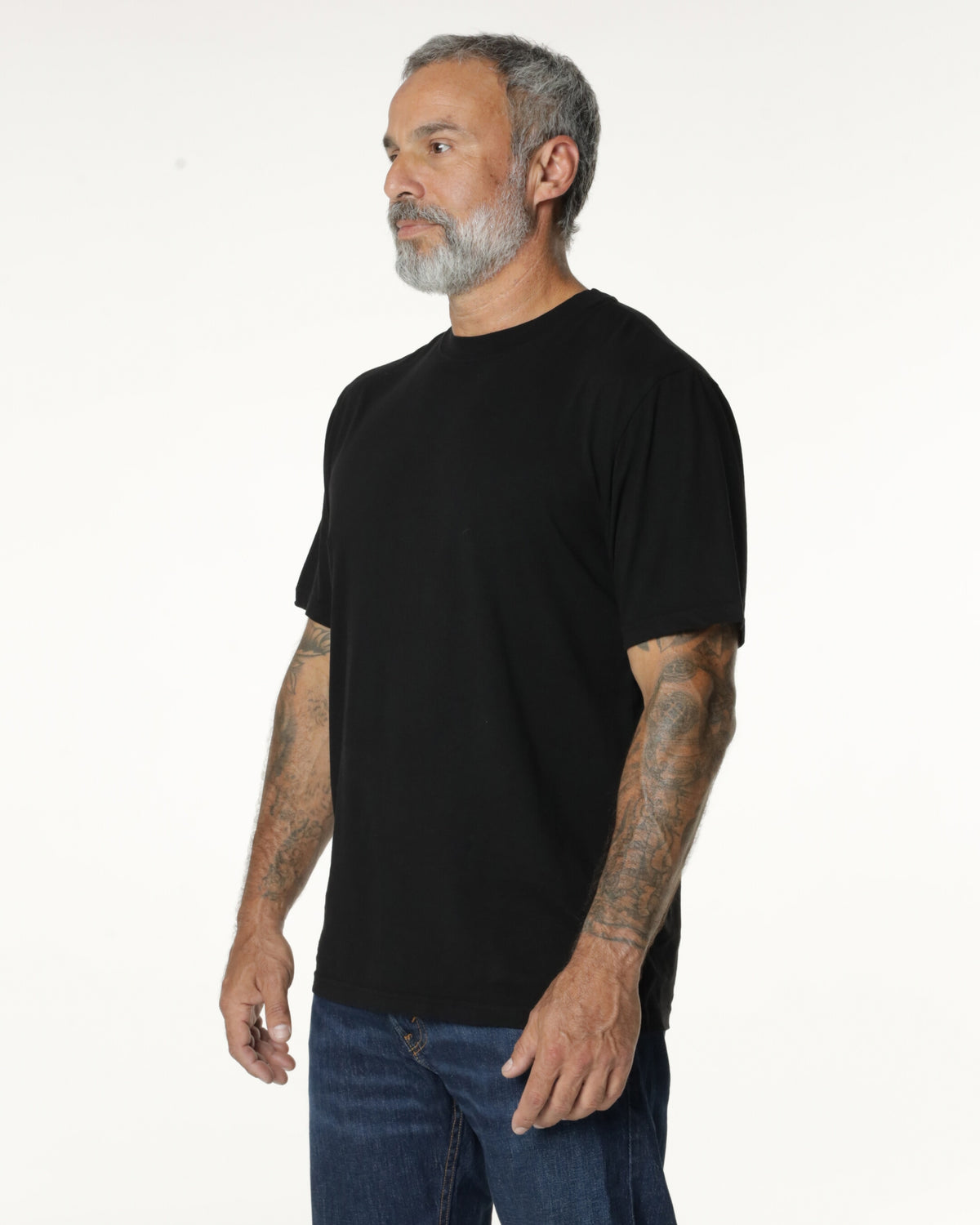 Man turned to the side, wearing a black Premium t-shirt. Model is 5'11", 198lbs wearing size L