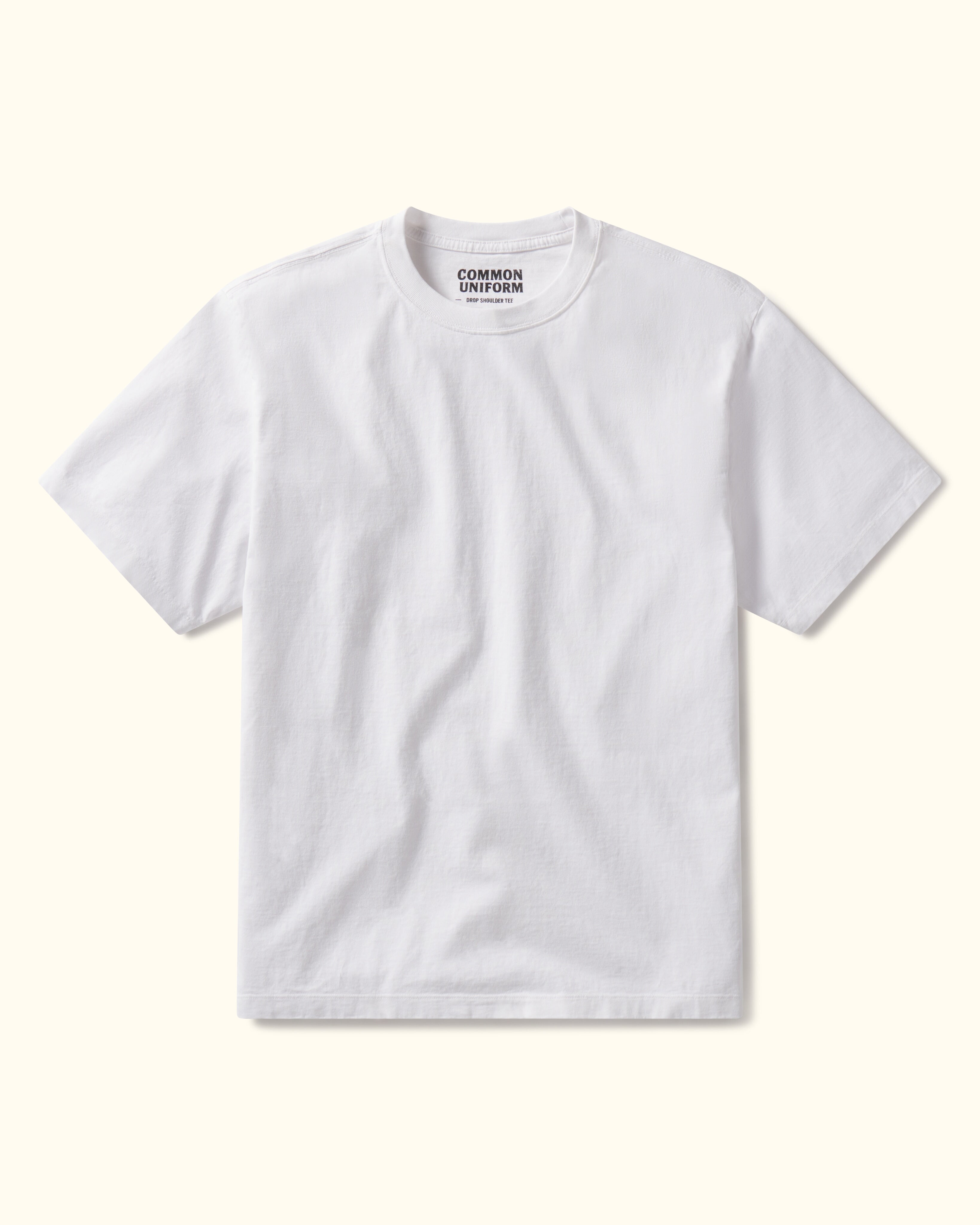 White t-shirt with 'Common Uniform' logo on a white background