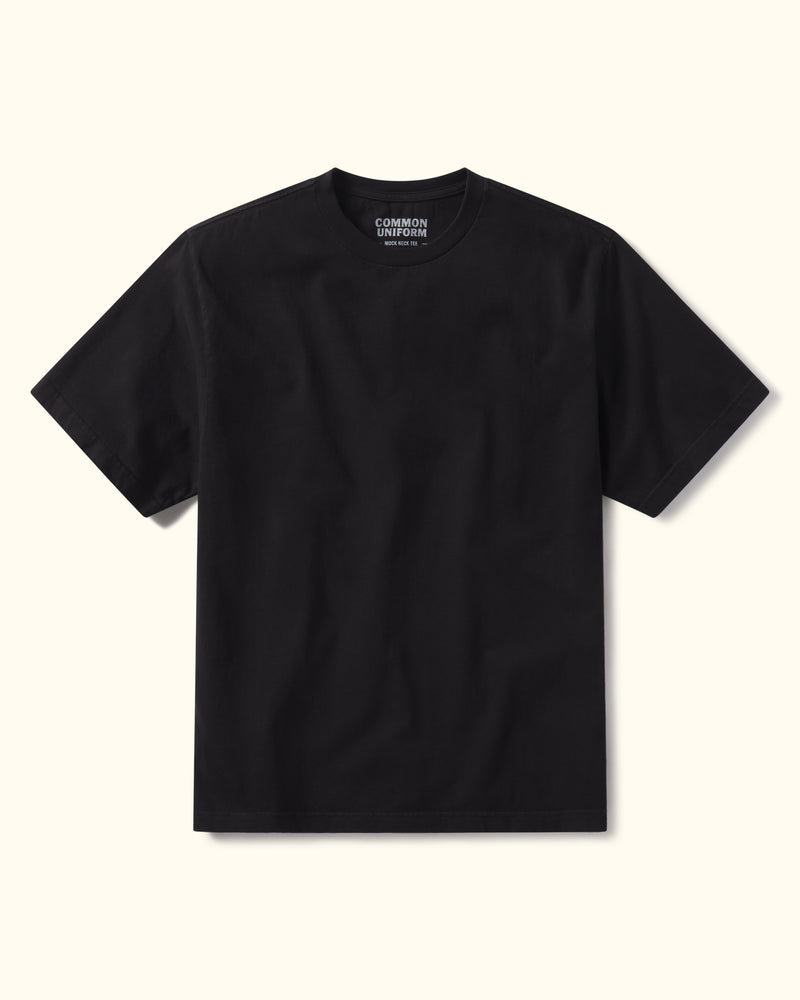 Black t-shirt with a brand logo on a beige background