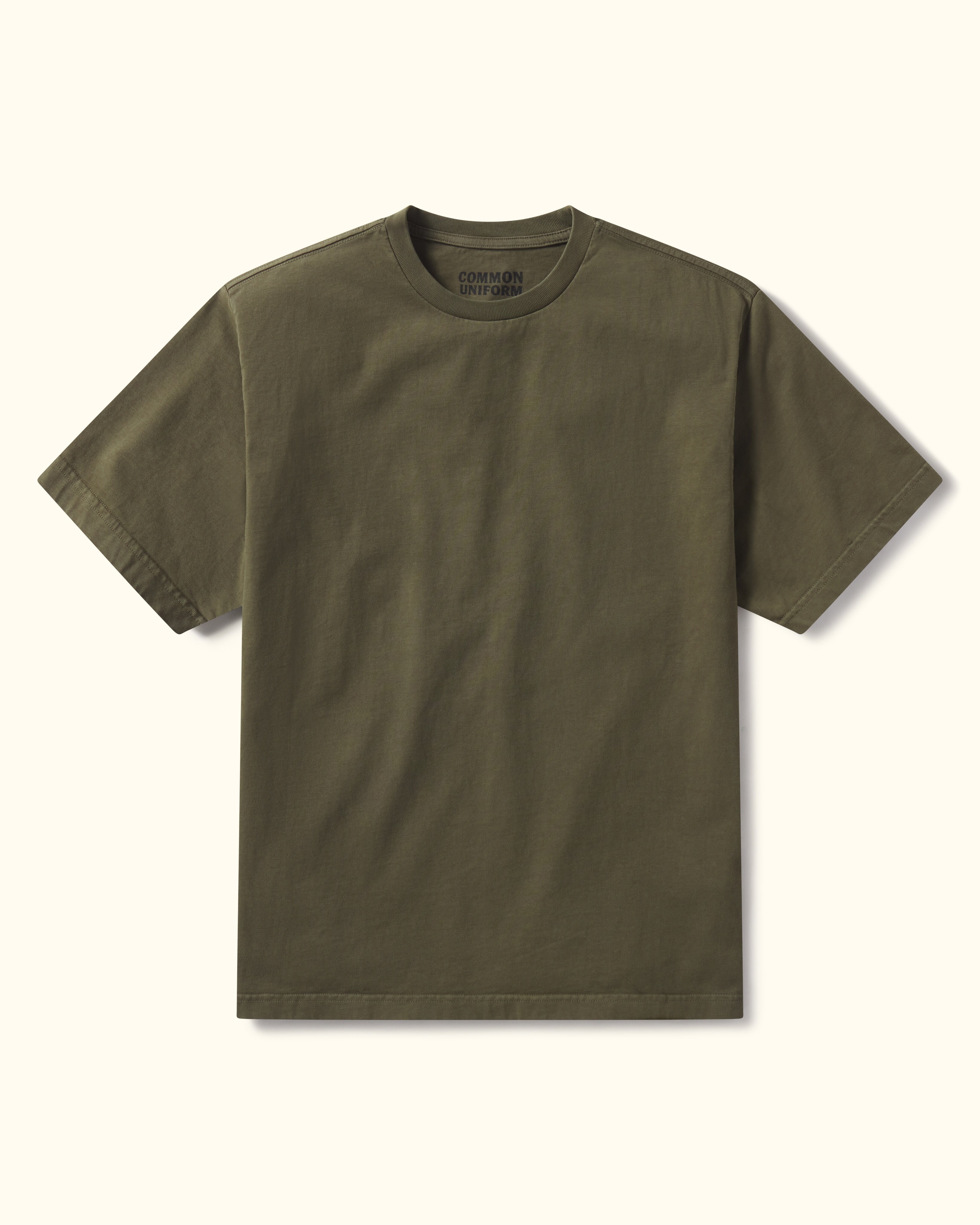 Military green t-shirt on a beige background
