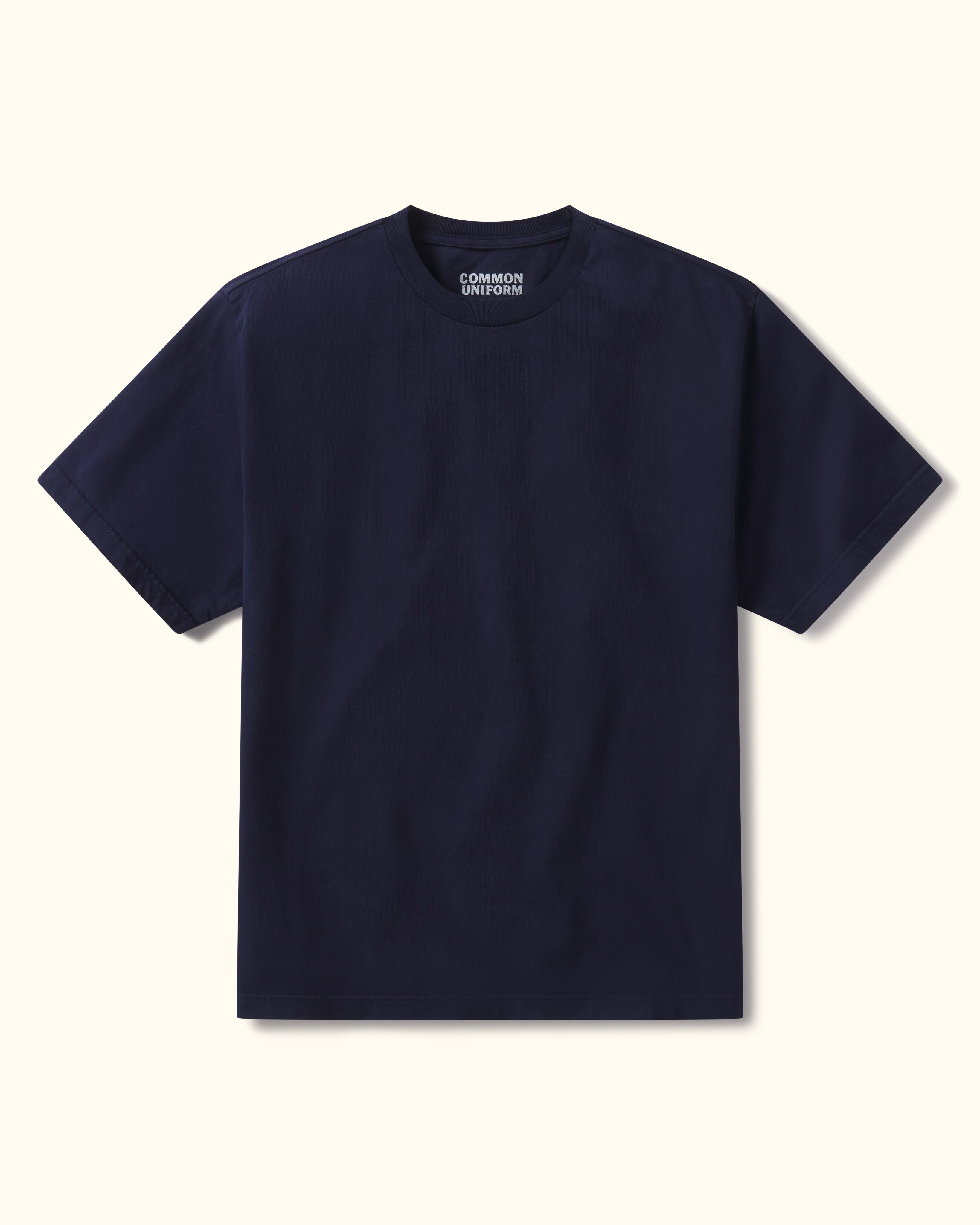 Navy blue t-shirt on a beige background