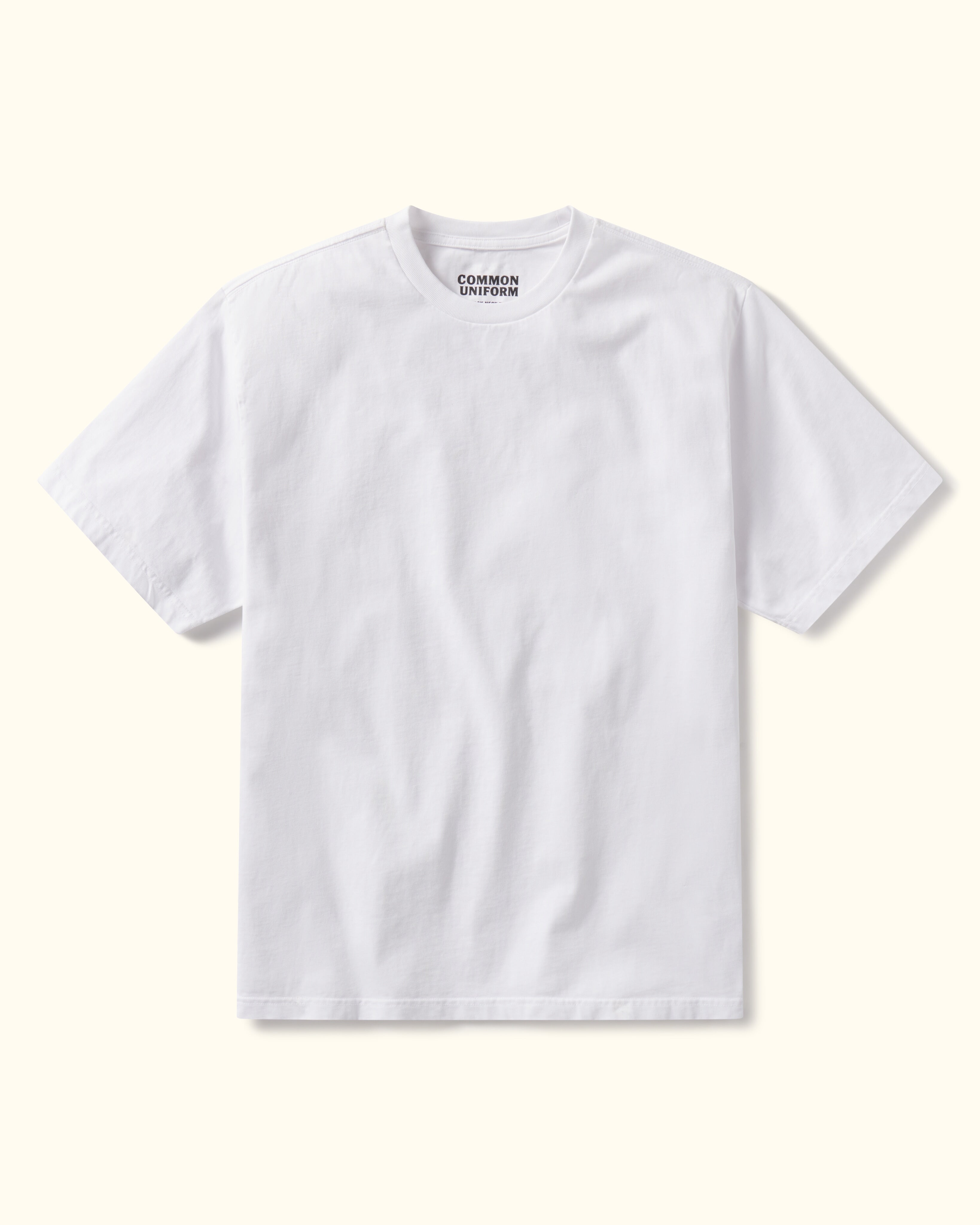 White t-shirt with 'Common Uniform' logo on a white background