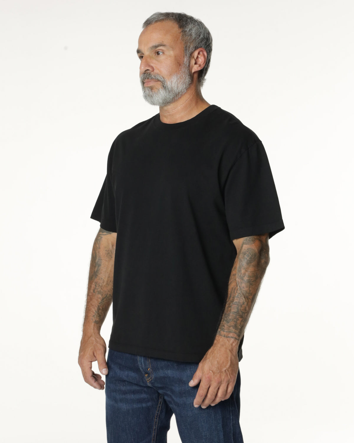 Man wearing a black Mock Neck t-shirt. Model is 5'11", 198lbs wearing size L