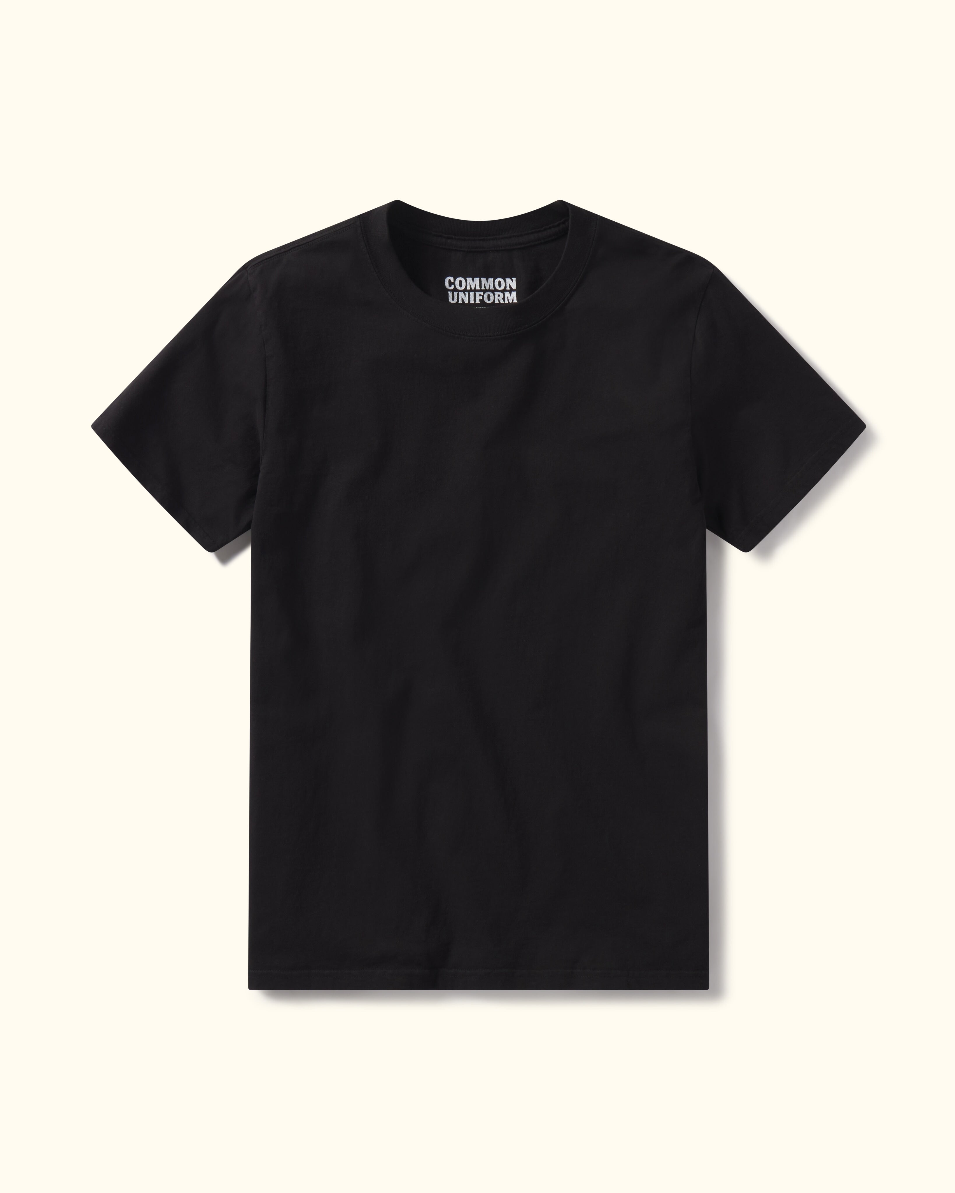 Black Premium t-shirt from 'Common Uniform' on white background.