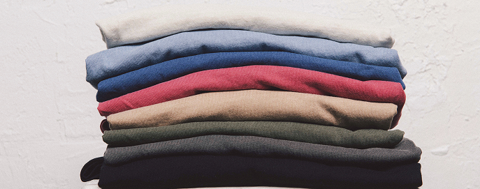 Stack of premium blank cotton t-shirts — wholesale bulk order from Common Uniform
